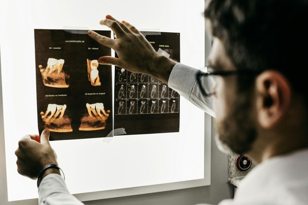 Dentist reviewing 3D dental scans for surgical planning