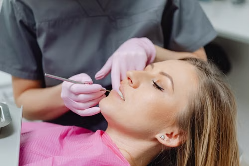 Dentist examining a relaxed patient during a routine dental check-up